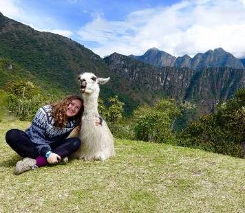 student with llama machu picchu